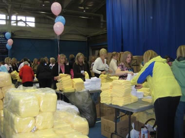conference Thousands of women take part in service by assembling hygiene, newborn and school kits at the 2008 Women's Conference held at Brigham Young University in Provo, Utah.